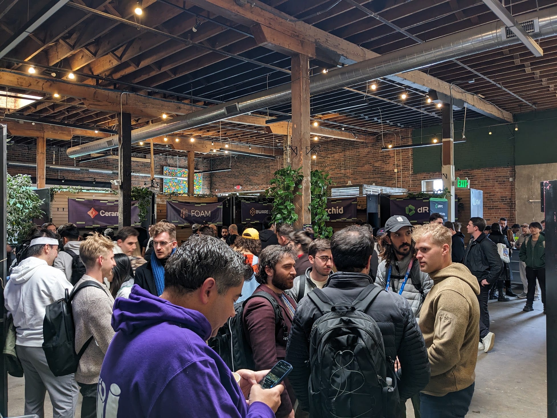 EthDenver crowd in a wood beamed venue